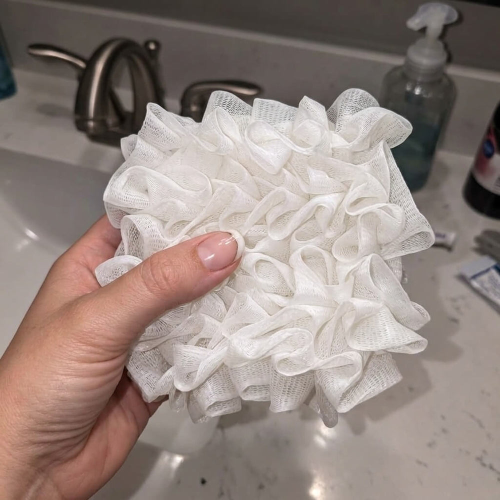 Customer using Albanua loofah sponge
